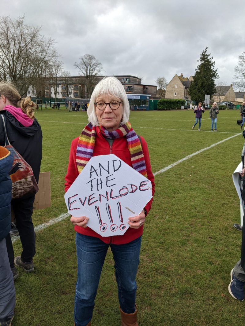 Sue Richards holds a placard that says "And the Evenlode"