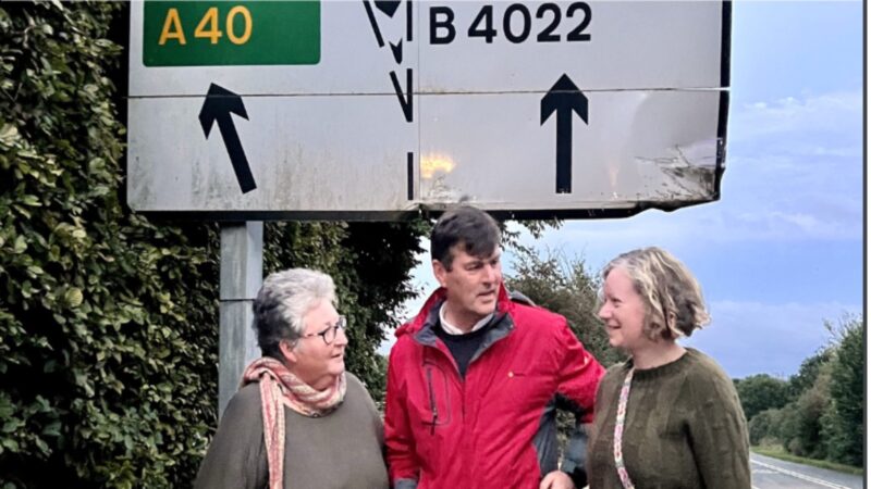 Councillors Aitman, Enright and Smith standing at Shores Green junction Witney